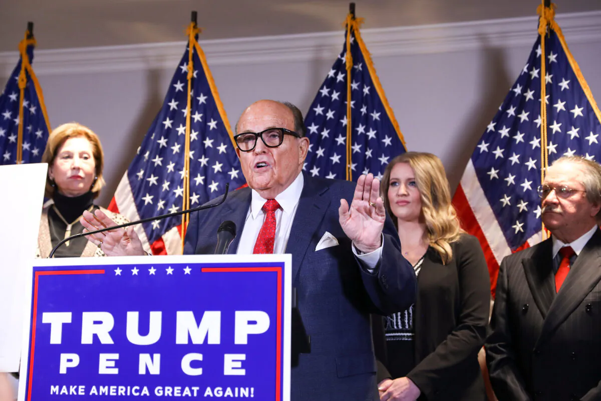 Trump lawyer and former New York City Mayor Rudy Giuliani speaks to media while flanked by Trump campaign lawyer Sidney Powell (L) and members of the Trump campaign legal team at a press conference at the Republican National Committee headquarters in Washington on Nov. 19, 2020. (Charlotte Cuthbertson/The Epoch Times)