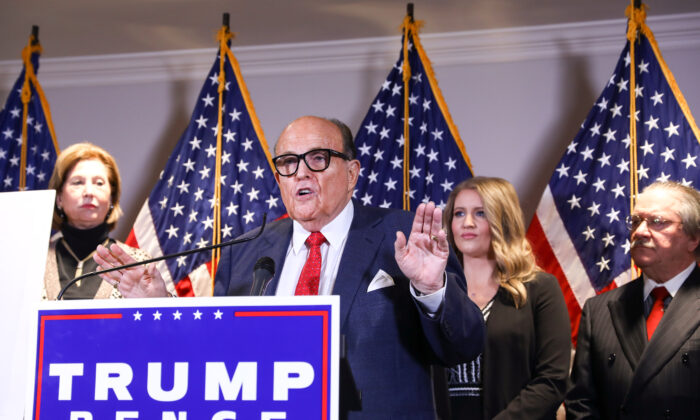 Trump lawyer and former New York City Mayor Rudy Giuliani speaks to media while flanked by Trump campaign lawyer Sidney Powell (L) and members of the Trump campaign legal team at a press conference at the Republican National Committee headquarters in Washington on Nov. 19, 2020. (Charlotte Cuthbertson/The Epoch Times)