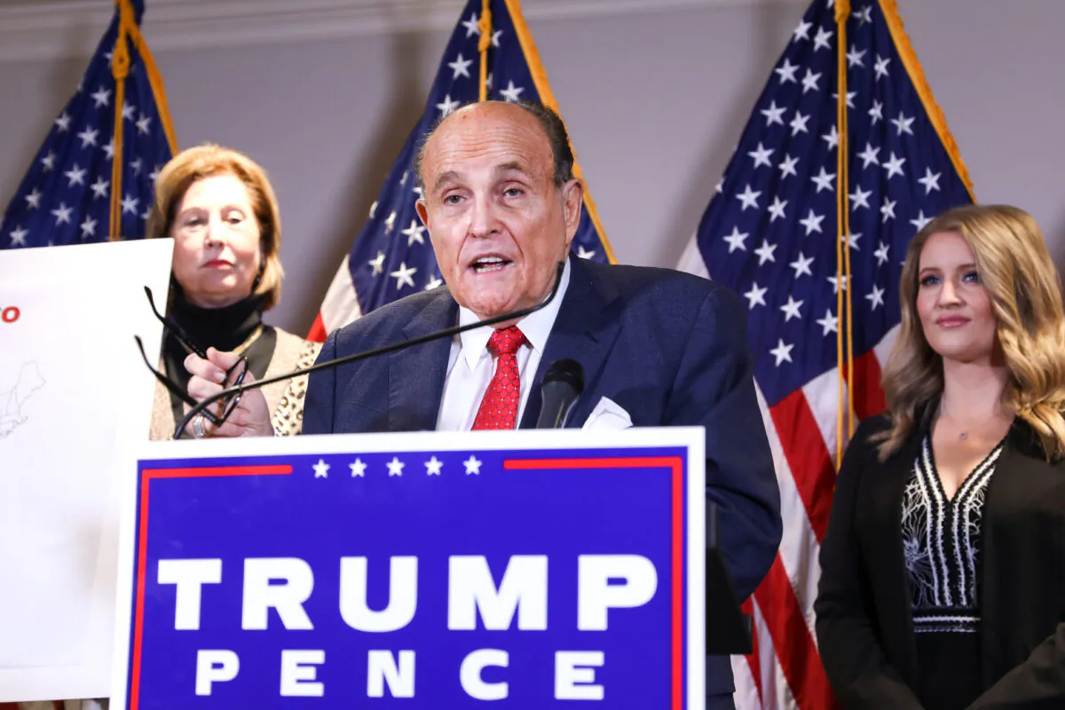 Trump lawyer and former New York City Mayor Rudy Giuliani speaks to media while flanked by Trump campaign lawyer Sidney Powell (L) and Trump campaign senior legal adviser Jenna Ellis at a press conference at the Republican National Committee headquarters in Washington on Nov 19, 2020. (Charlotte Cuthbertson/The Epoch Times)