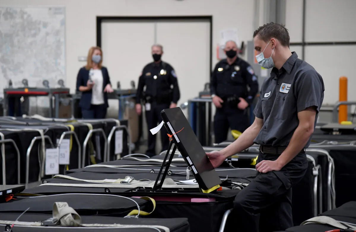 A Clark County election worker checks a voting machine among others that are boxed up at the Clark County Election Department in Las Vegas, Nev., on Nov. 6, 2020. (Ethan Miller/Getty Images)