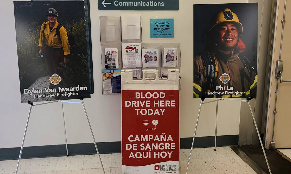 Pictures of two firefighters injured in the Silverado Fire flank a sign indicating a blood drive being held in their honor at the Orange County Global Medical Center in Santa Ana, Calif., on Nov. 19, 2020. (Courtesy of the Orange County Fire Authority)