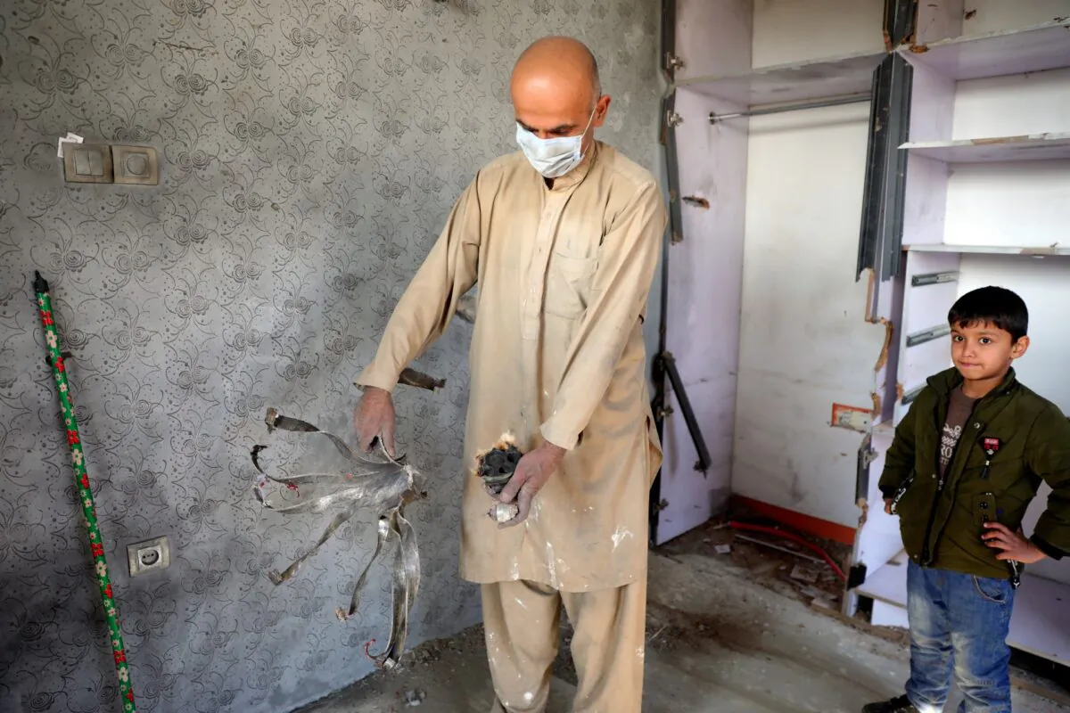 An Afghan man holds a shell at a mortal shell attack site in Kabul, Afghanistan, on Nov. 21, 2020. (Rahmat Gul/AP Photo)