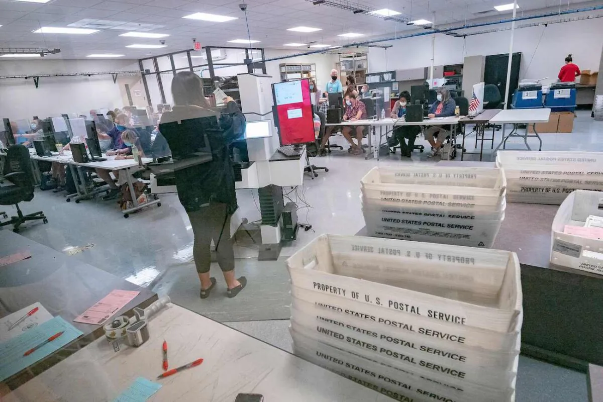 Poll workers count ballots inside the Maricopa County Election Department in Phoenix, Ariz., on Nov. 5, 2020. (Olivier Touron/AFP via Getty Images)
