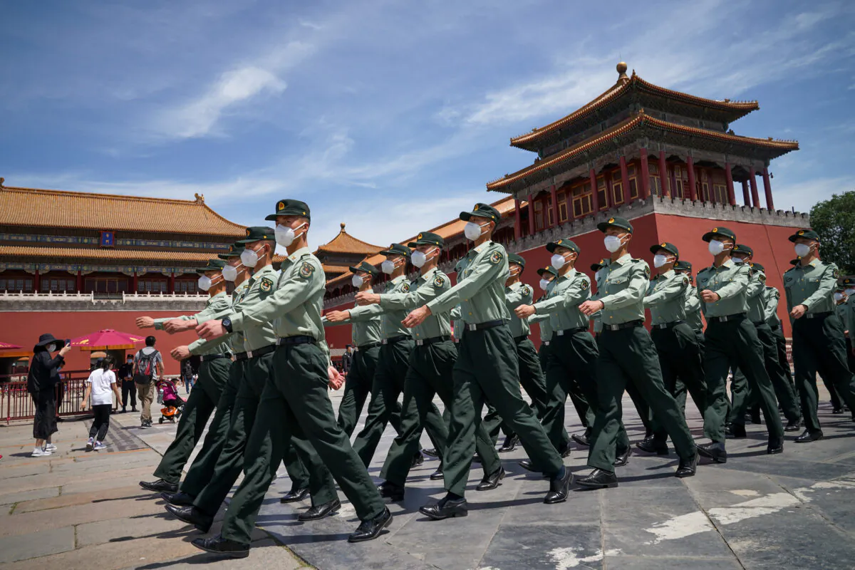 Soldiers of the People's Liberation Army march in front of the entrance of the Forbidden City in Beijing on May 20, 2020. (Andrea Verdelli/Getty Images)