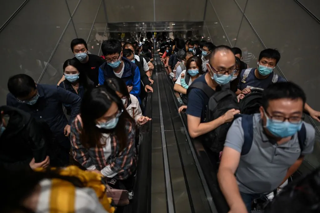 Passengers wearing masks arrive at Pudong International Airport in Shanghai on Sept. 29, 2020. (Hector Retama/AFP via Getty Images)