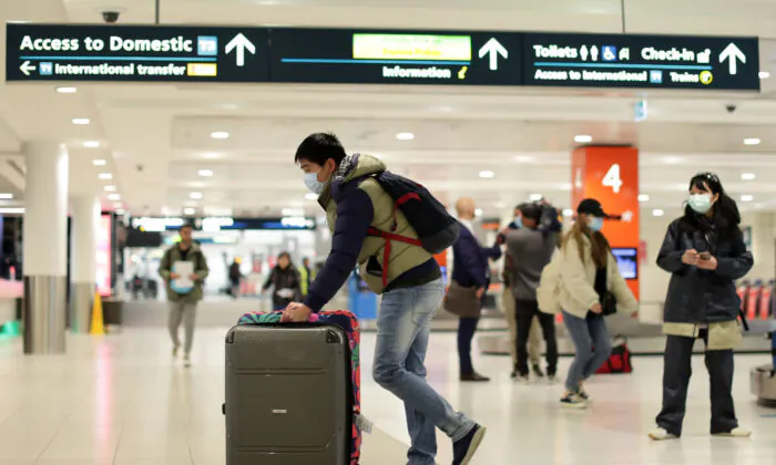A passenger off a Melbourne to Sydney flight collects their luggage at Sydney domestic airport on July 07, 2020 in Sydney, Australia.  (Mark Metcalfe/Getty Images)