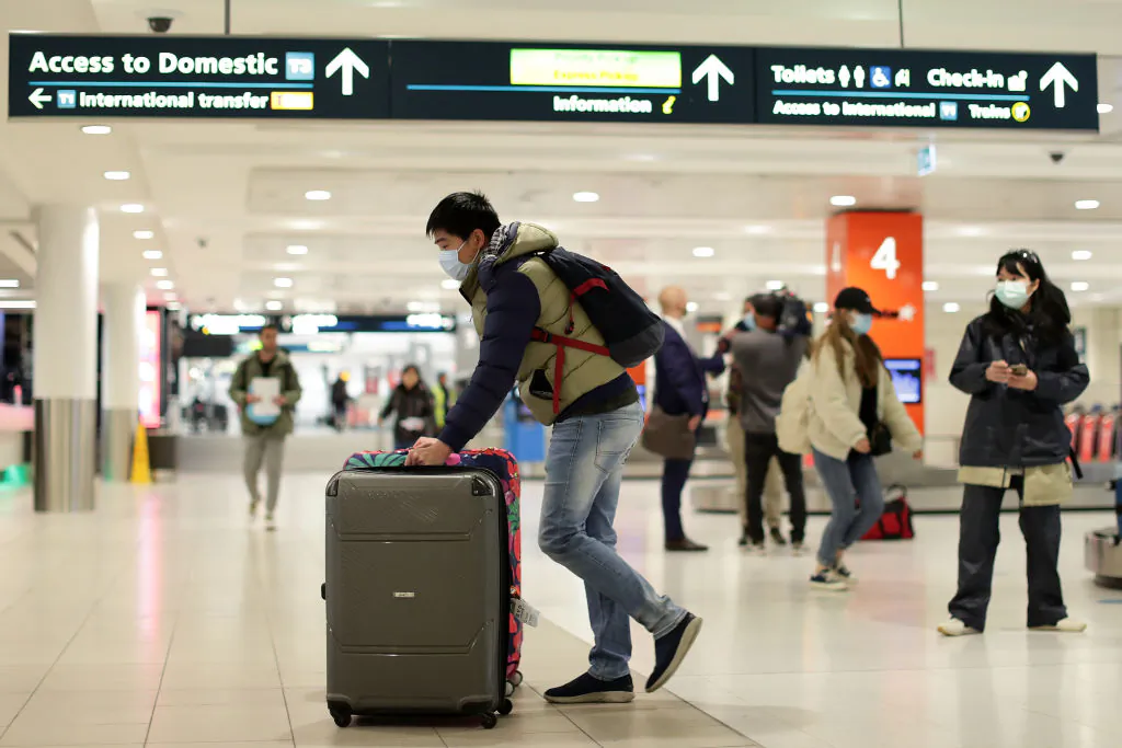 A passenger off a Melbourne to Sydney flight collects their luggage at Sydney domestic airport on July 07, 2020 in Sydney, Australia.  (Mark Metcalfe/Getty Images)