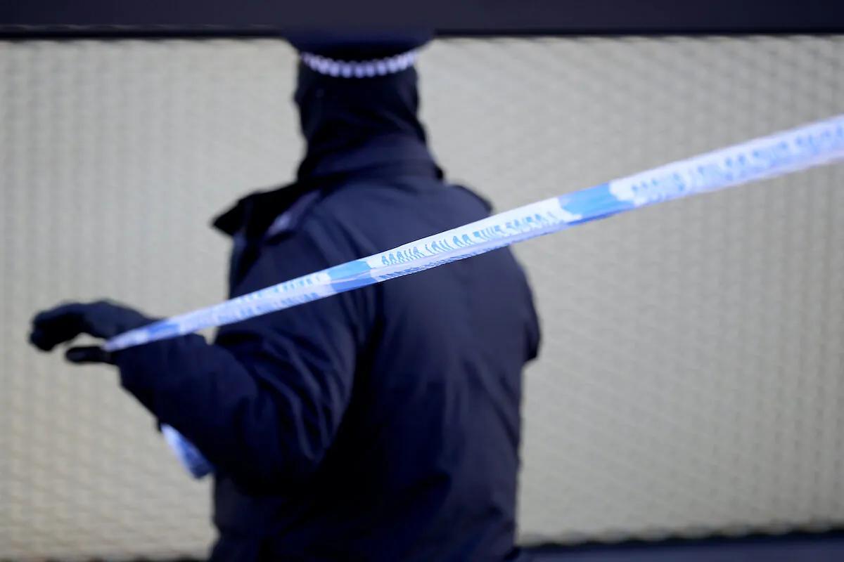 In this file image a policeman sets up tape at a crime scene in London on April 5, 2018. (Christopher Furlong/Getty Images)