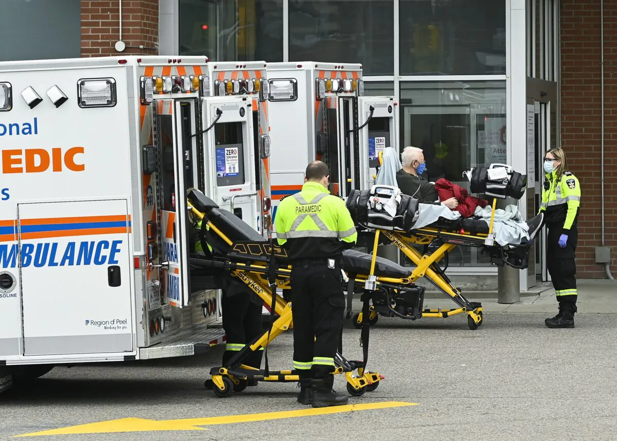 Paramedics transport a man to the emergency department of the Mississauga Hospital in Mississauga, Ont., on Nov. 19, 2020. (The Canadian Press/Nathan Denette)