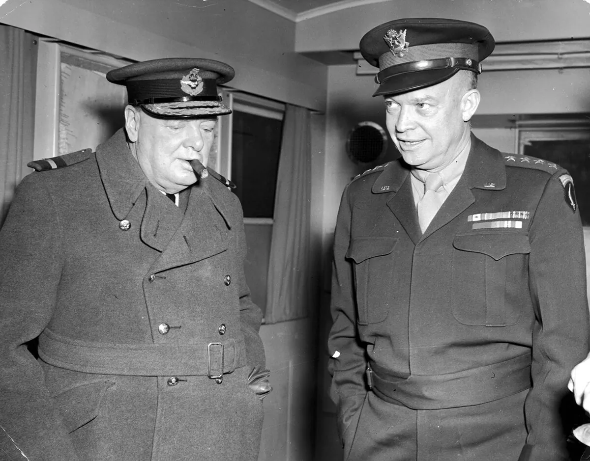 14th November 1944: British Prime Minister Winston Churchill smokes a cigar and listens to Supreme Allied Commander Gen. Dwight D. Eisenhower speak during World War II. (Hulton Archive/Getty Images)