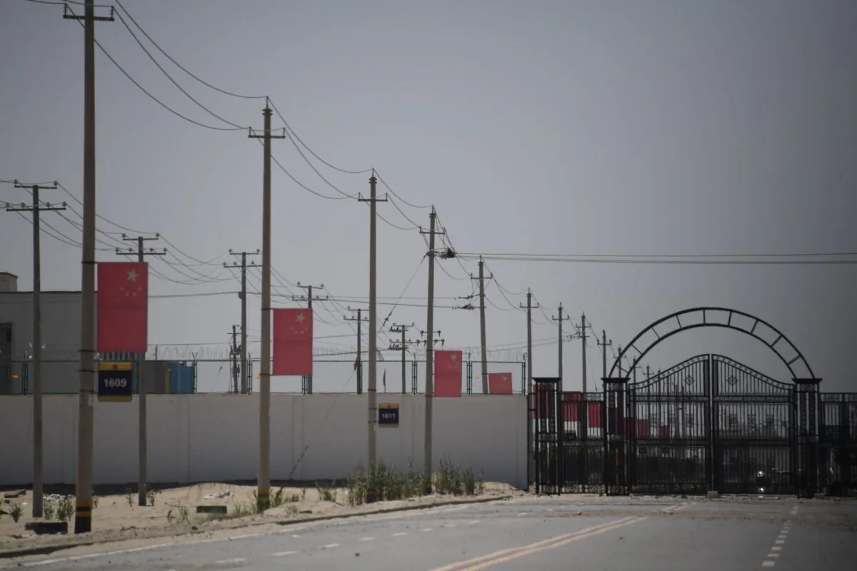 Chinese flags on a road leading to a facility believed to be a reeducation camp where mostly Muslim ethnic minorities are detained, on the outskirts of Hotan in China's northwestern Xinjiang region on May 31, 2019. (Greg Baker/AFP via Getty Images)