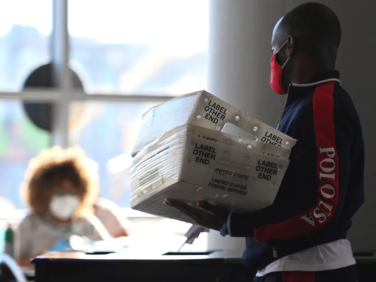 Employees of the Fulton County Board of Registration and Elections process ballots in Atlanta, Ga., on Nov. 4, 2020. (Brandon Bell/Reuters)