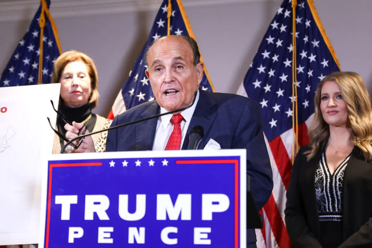 Trump lawyer and former New York City Mayor Rudy Giuliani speaks to media while flanked by lawyer Sidney Powell (L) and Trump campaign senior legal adviser Jenna Ellis at a press conference at the Republican National Committee headquarters in Washington on Nov 19, 2020. (Charlotte Cuthbertson/The Epoch Times)