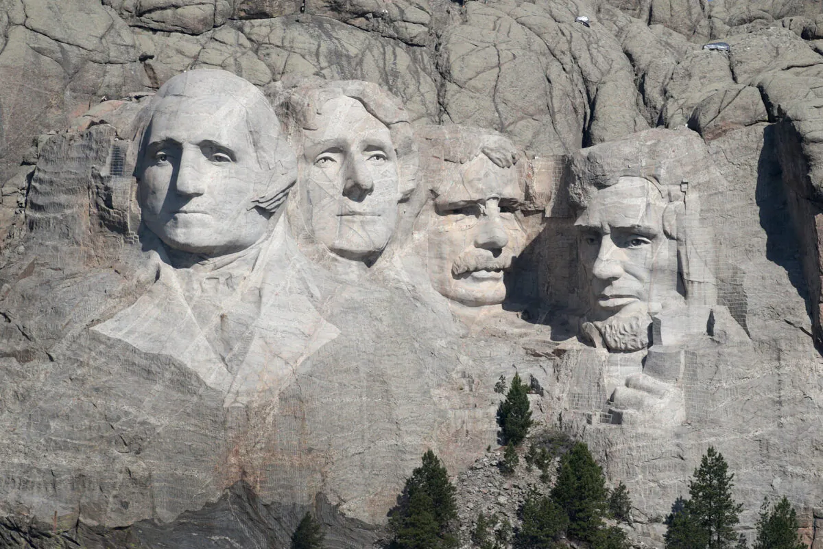 The busts of presidents George Washington, Thomas Jefferson, Theodore Roosevelt, and Abraham Lincoln tower over the Black Hills at Mount Rushmore National Monument near Keystone, S.D., on July 2, 2020. (Scott Olson/Getty Images)