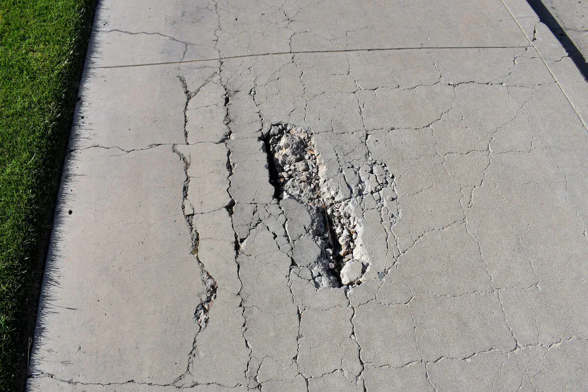 In addition to looking unattractive, a crumbling concrete sidewalk and driveway can be hazardous to walk on. (Sue A Dunning/Shutterstock)