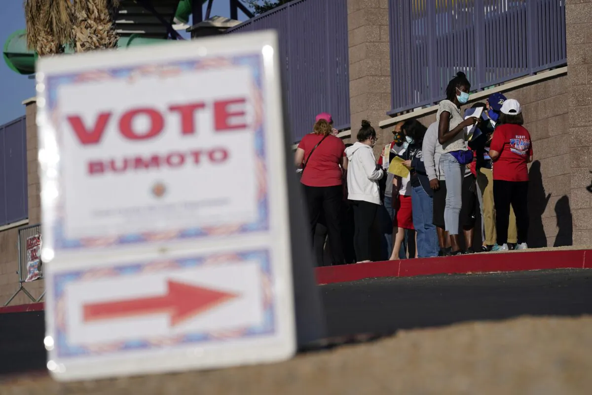 People wait in line to vote at a polling place on Election Day in Las Vegas, on Nov. 3, 2020. (John Locher/AP Photo)