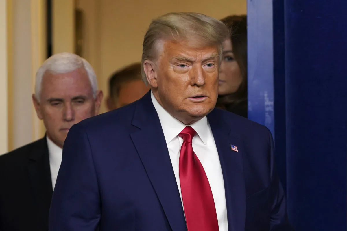 President Donald Trump, followed by Vice President Mike Pence (L) walks into the briefing room at the White House in Washington on Nov. 24, 2020. (Susan Walsh/AP Photo)