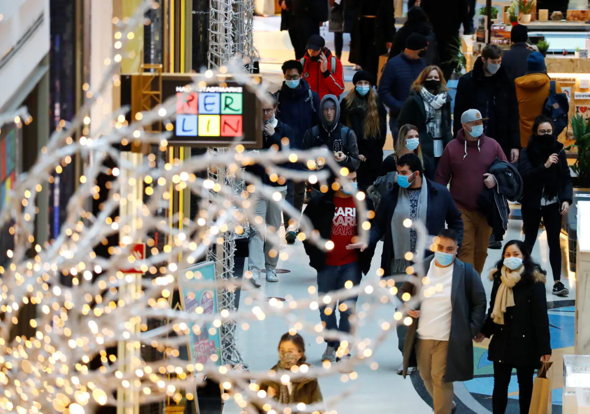 People wear protective face masks as they walk beside Christmas decoration at a shopping mall amid the COVID-19 outbreak in Berlin, Germany, on Nov. 21, 2020. (Fabrizio Bensch/Reuters)