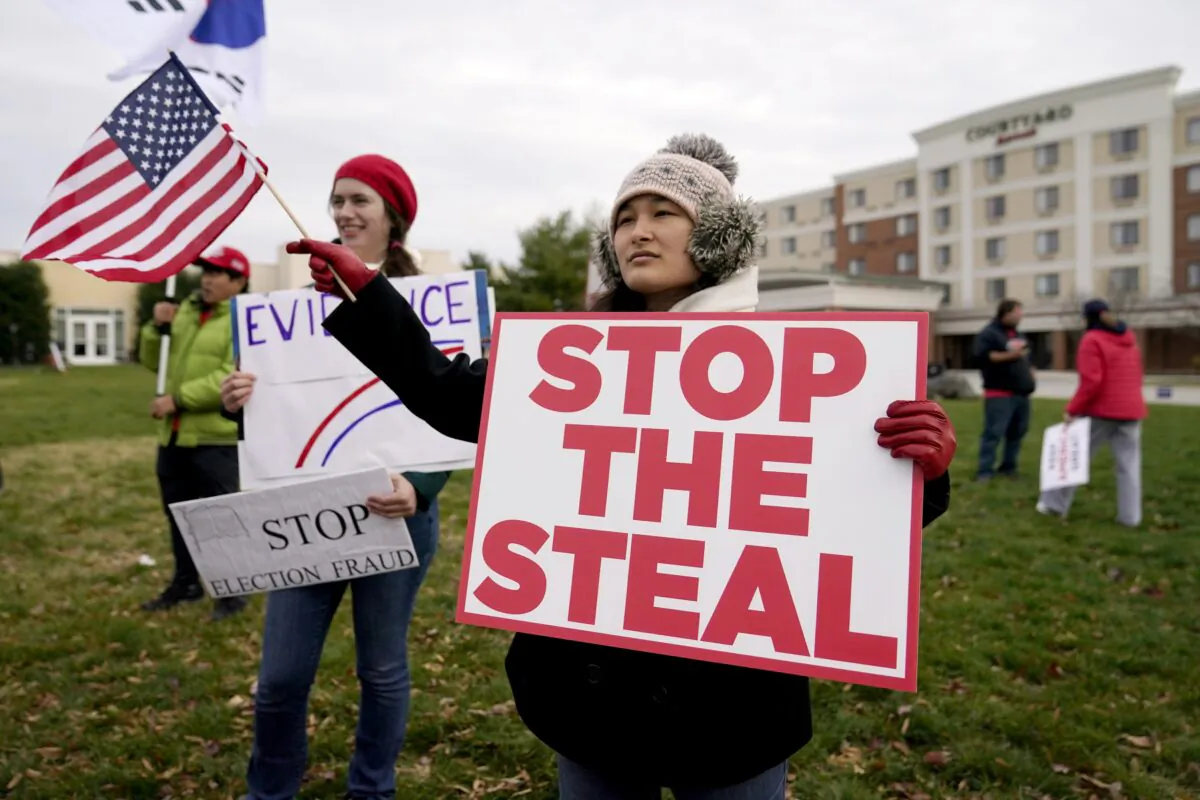 Supporters of President Donald Trump gather outside of the Wyndham Hotel before a  Pennsylvania State Senate Majority Policy Committee hearing, in Gettysburg, Pa., on Nov. 25, 2020. (Julio Cortez/AP Photo)
