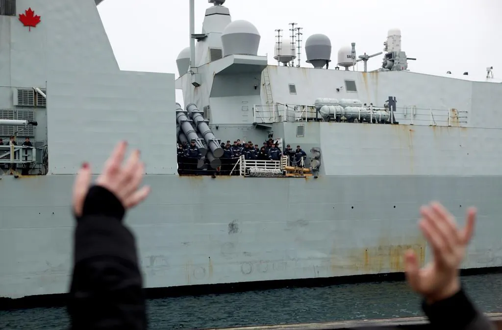 Family members and friends wait to welcome home the crew aboard the HMCS Ottawa following its four month deployment to the Asia-Pacific region as it returns to CFB Esquimalt in Victoria, B.C., on Dec. 18, 2019. (Chad Hipolito/The Canadian Press)