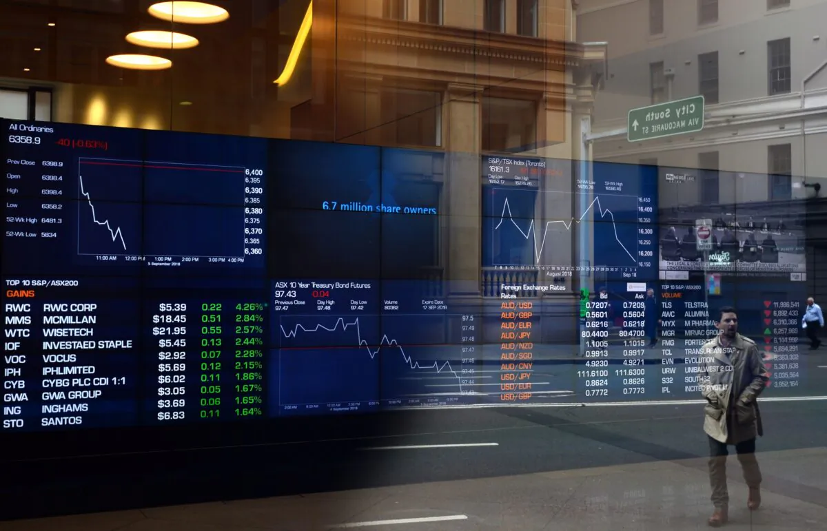 A pedestrian is reflected in a window of the Australian Securities Exchange (ASX) in Sydney, on Sep. 5, 2018. (Saeed Khan/AFP via Getty Images)