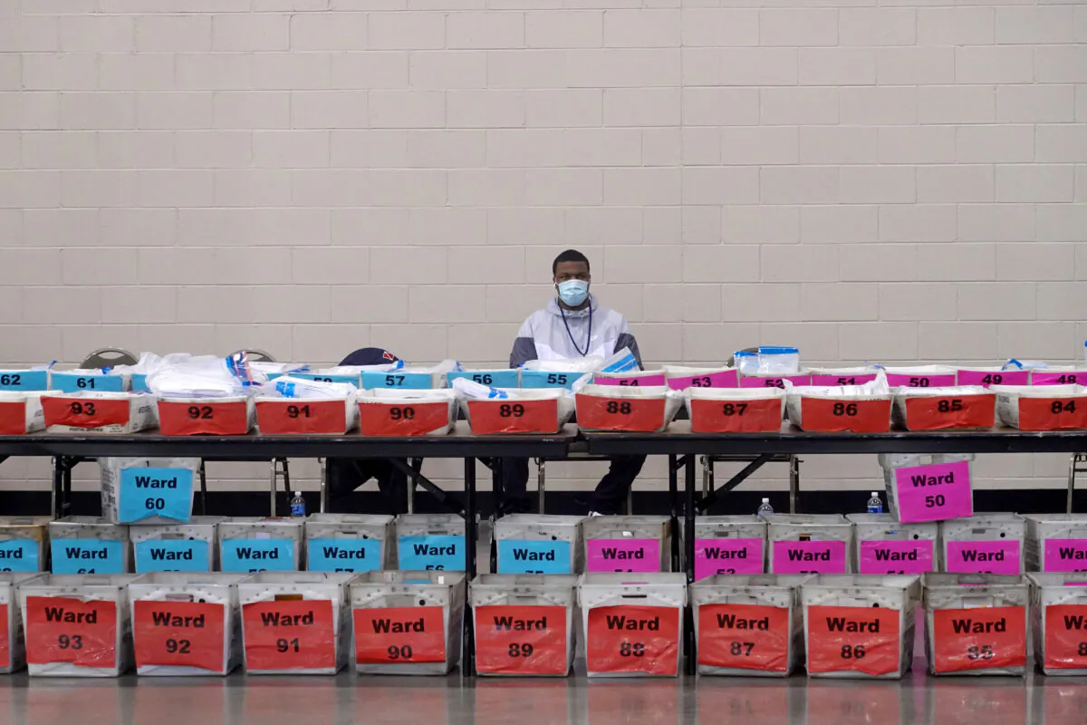Election officials wait as procedural issues are argued during the process of recounting ballots from the Nov. 3 election at the Wisconsin Center in Milwaukee, Wis., on Nov. 20, 2020. (Scott Olson/Getty Images)