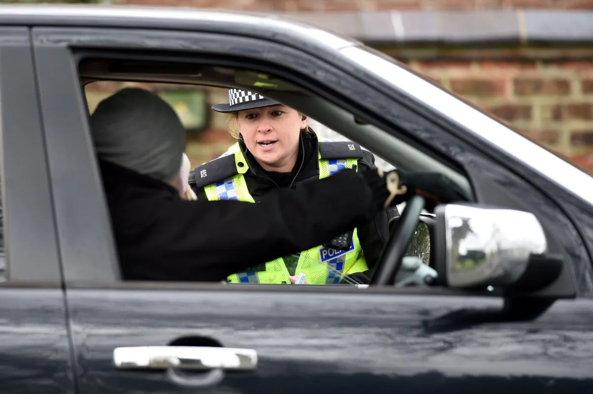 During the first national lockdown, officers from North Yorkshire Police stop motorists in cars to check that their travel is "essential", in line with the British government's COVID-19 advice in York, northern England, on March 30, 2020. (Oli Scarff/AFP via Getty Images)