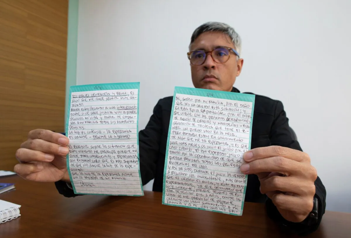 Jesus Loreto, an attorney representing Tomeu Vadell, one of six U.S. oil executives jailed for three years in Venezuela, shows a letter written by Vadell, in Caracas, Venezuela, on Nov. 25, 2020. (Ariana Cubillos/AP Photo)