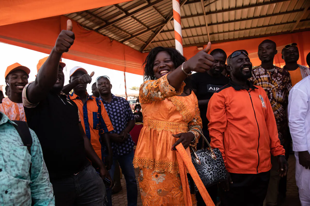 Supporters of President Roch Marc Christian Kabore celebrate in Ouagadougou as they learn he will serve another five years as Burkina Faso's president, according to provisional results announced by the National Independent Electoral Commission on Nov 26, 2020. (AP Photo/Sophie Garcia)
