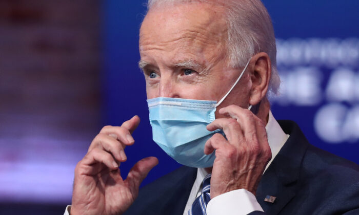 Joe Biden removes his mask to address the media about the Trump Administration’s lawsuit to overturn the Affordable Care Act at the Queen Theater in Wilmington, Del., on Nov. 10, 2020. (Joe Raedle/Getty Images)