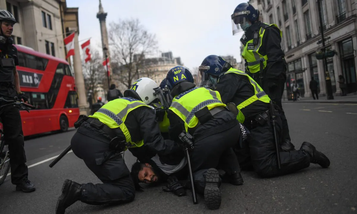 A man is seen being restrained by police during a protest in London, on Nov. 28, 2020. (Peter Summers/Getty Images)
