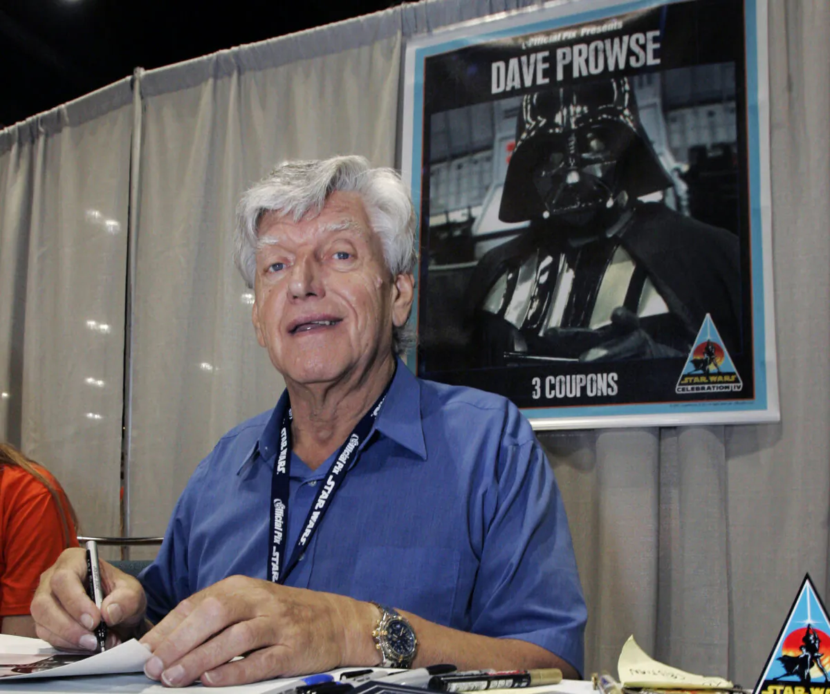 Actor David Prowse, who was the man in the black Darth Vader suit in the first Star Wars film, signs autographs at Star Wars Celebration IV, marking the 30th anniversary of the release of the first film in the Star Wars saga, in Los Angeles, on May 26, 2007. (Reed Saxon/AP Photo)