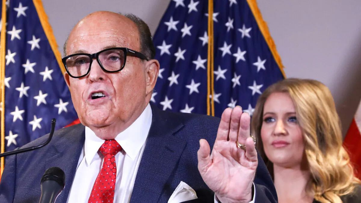 President Donald Trump lawyer and former New York City Mayor Rudy Giuliani speaks to media while flanked by Trump campaign senior legal adviser Jenna Ellis (R) at a press conference at the Republican National Committee headquarters in Washington on Nov. 19, 2020. (Charlotte Cuthbertson/The Epoch Times)