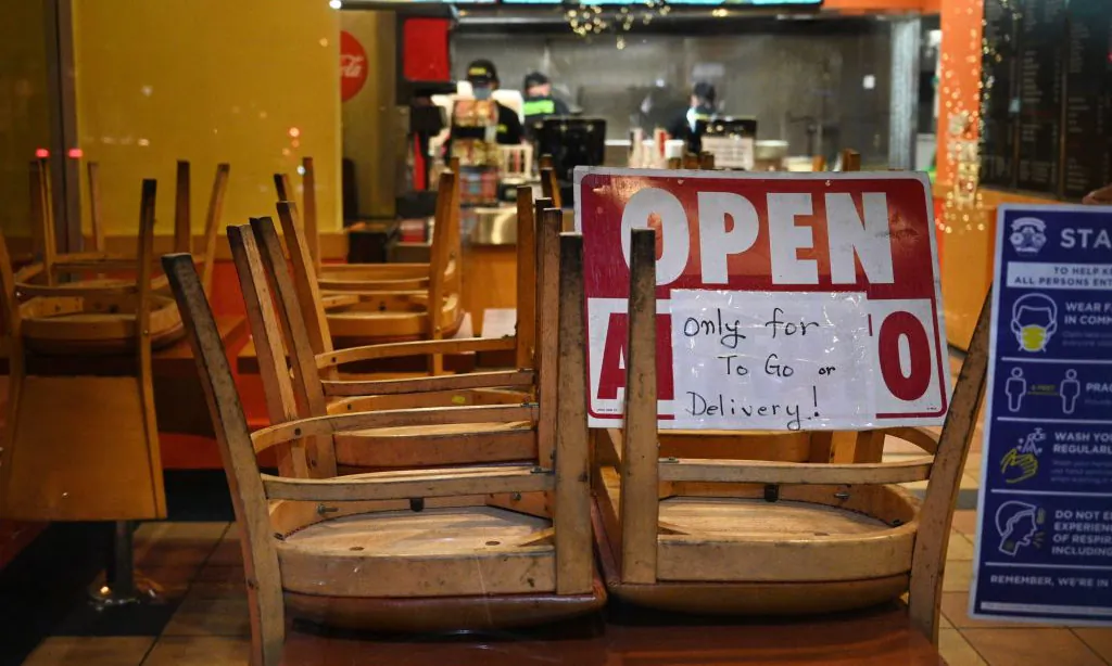 Employees work in a restaurant open for to-go or delivery orders only in Burbank, Calif., on Nov. 23, 2020. (Robyn Beck/AFP via Getty Images)