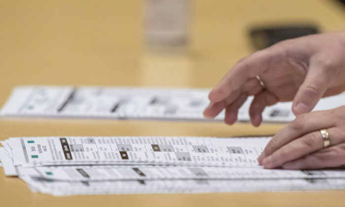 A election worker shows ballots to representatives for President Donald Trump during the presidential recount vote for Dane County, in Madison, Wisconsin, on Nov. 20, 2020. (Andy Manis/Getty Images)