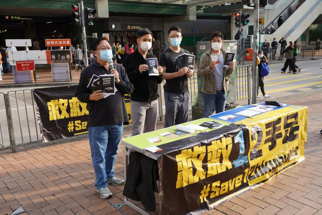 Pro-democracy district councilors from the local Kwai Tsing District set up a booth in Hong Kong to raise awareness of the 12 Hongkongers currently held in China on Nov. 30, 2020. (Yu Gang/The Epoch Times)