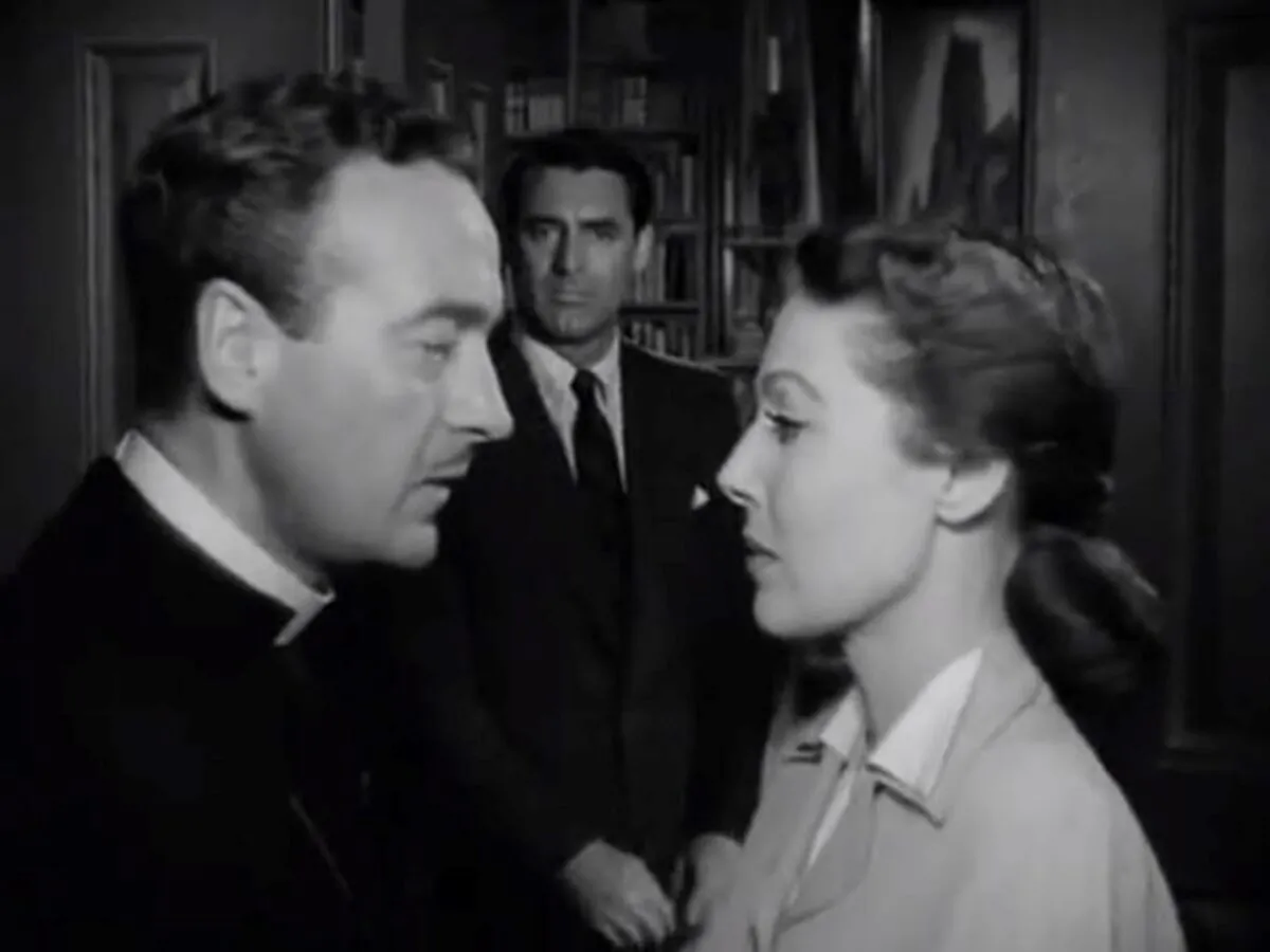 (Foreground) Bishop Brougham (David Niven, L) and his wife (Loretta Young) discuss the day’s plans while (background) Dudley (Cary Grant) eavesdrops. (RKO Radio Pictures).