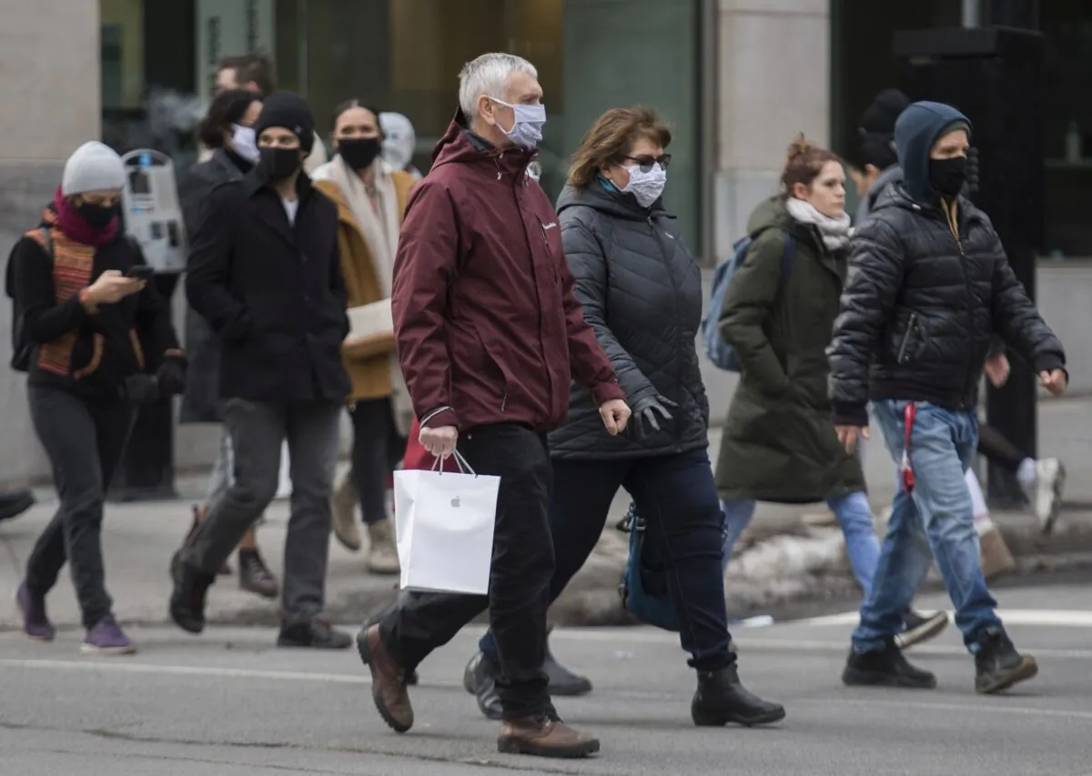 People walk along a street in Montreal on Nov. 29, 2020, as a partial COVID-19 lockdown continues in Quebec. (The Canadian Press/Graham Hughes)