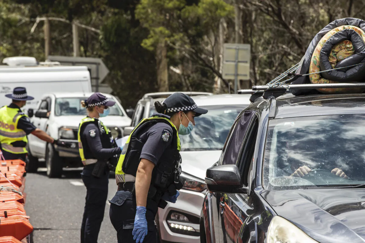 Police officers patrol and check for entry permits to Victoria at a border checkpoint in Mallacoota, Australia on Dec. 29, 2020. (Diego Fedele/Getty Images)