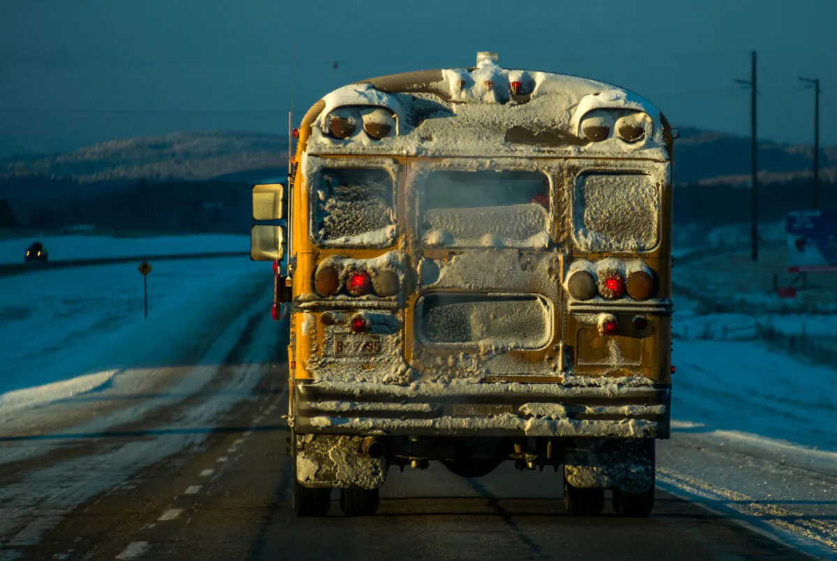 A school bus makes it's way during morning's freezing temperatures reaching bellow 25 degrees Celsius on Trans Canada Highway #1 east of Cochrane , Canada, on Dec. 4, 2013. (Joe Klamar/AFP via Getty Images)
