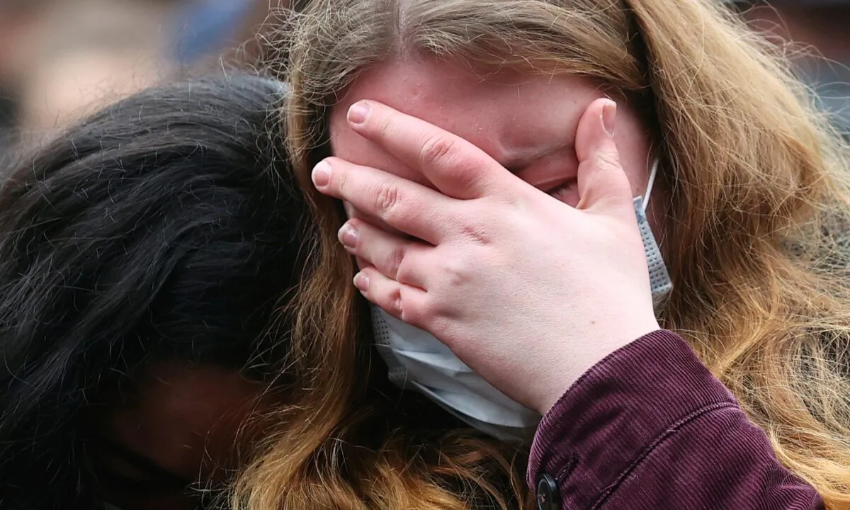 A person reacts at the site where a car crashed into pedestrians in Trier, Germany, on Dec. 2, 2020. (Kai Pfaffenbach/Reuters)
