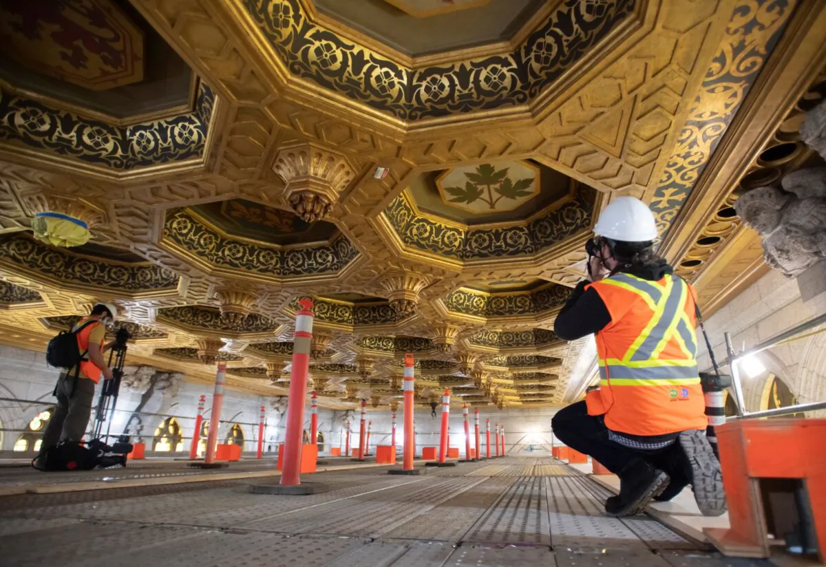Members of the media record images of the roof of the Senate from scaffolding during a tour of the Centre block renovations on December 2, 2020 in Ottawa. (The Canadian Press/Adrian Wyld)