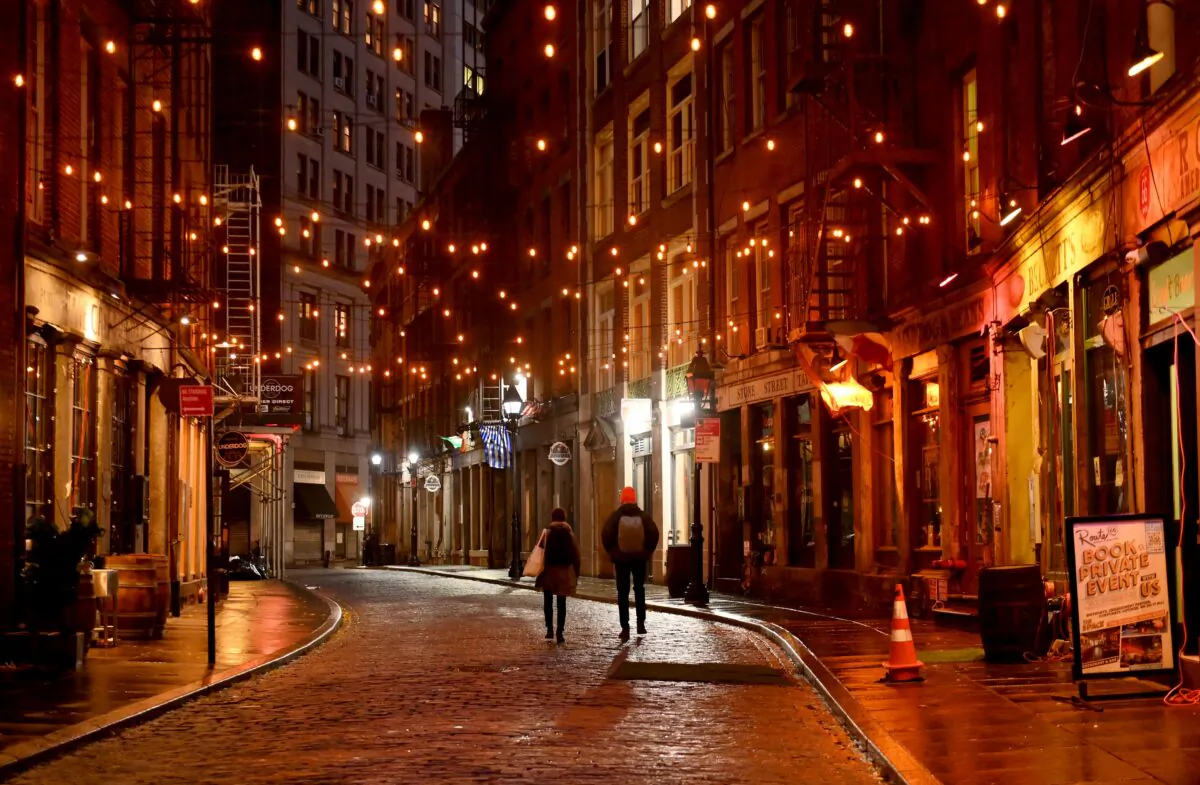 A couple walks along empty Stone Street in the financial district of New York City on Nov. 30, 2020. in New York City. (Angela Weiss/AFP via Getty Images)
