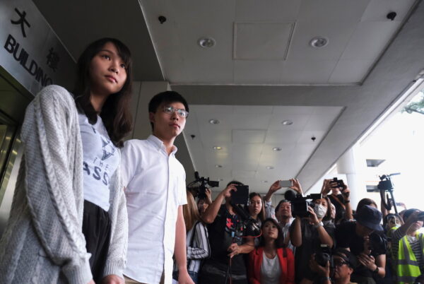Pro-democracy activists Joshua Wong and Agnes Chow leave the Eastern Court after being released on bail over charged with unauthorised assembly near the police headquarters during anti-government protests in Hong Kong