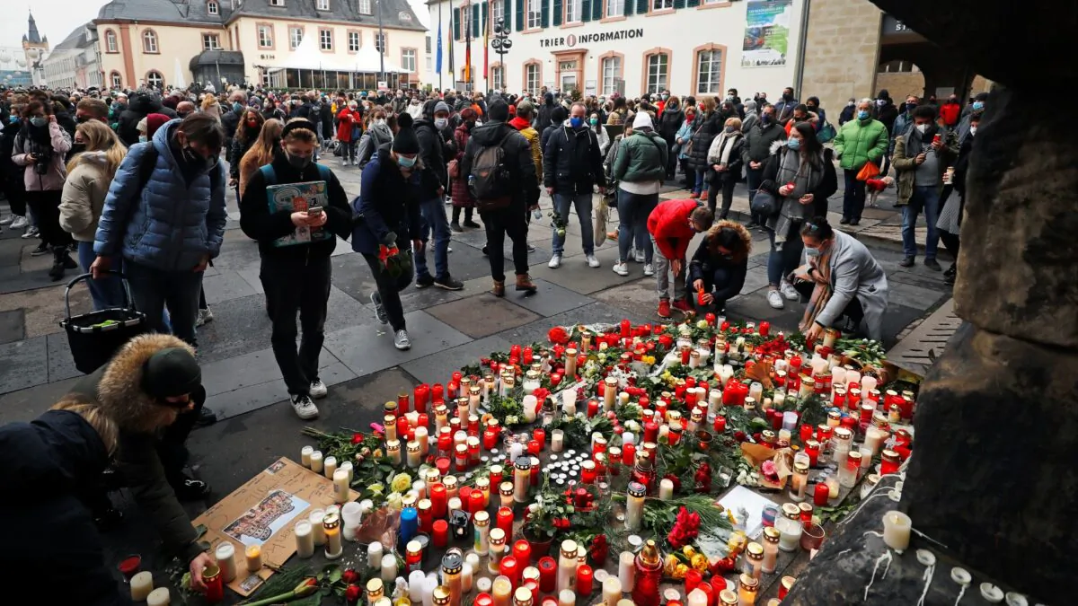 People pay their respects near the site where a car crashed into pedestrians in Trier, Germany, on Dec. 2, 2020. (Kai Pfaffenbach/Reuters)