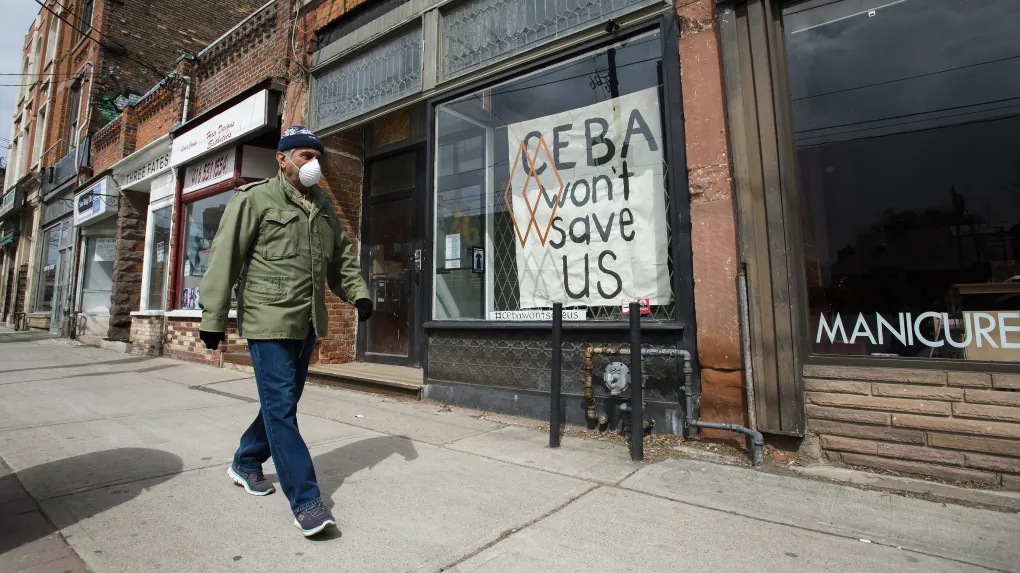 A closed store front boutique business called Francis Watson pleads for help displaying a sign in Toronto on April 16, 2020. (The Canadian Press/Nathan Denette)