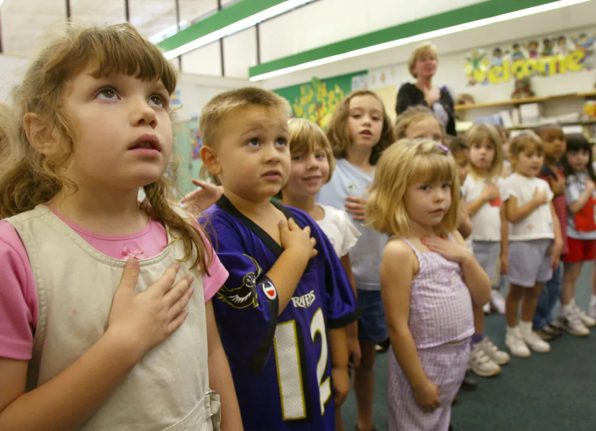 SUNDERLAND, MD - SEPTEMBER 17:  Sarah Henderson (L) and children from Mrs. Morrow's kindergarden class at Sunderland Elementry school recite the Pledge of Allegiance September 17, 2002 in Sunderland, Maryland. The children were participating in the "The Pledge Across America", a national recitation of the Pledge of Allegiance.  (Photo by Mark Wilson/Getty Images)