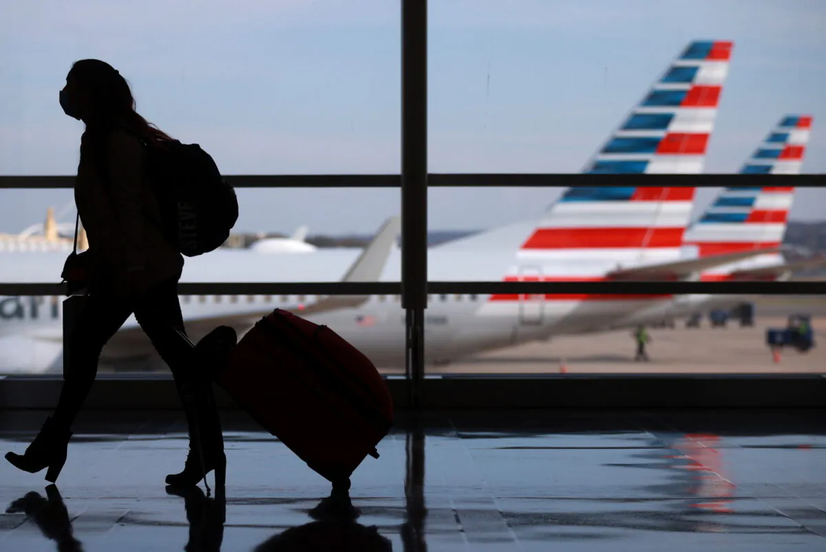 A person walks at Reagan National Airport ahead of the Thanksgiving holiday in Arlington, Va., on Nov. 25, 2020. (Hannah McKay/Reuters)