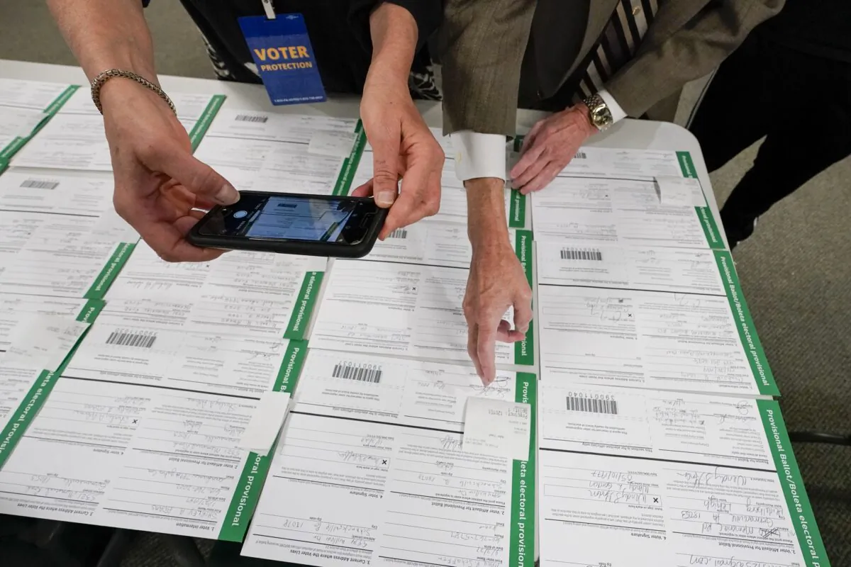 A canvas observer photographs Lehigh County provisional ballots as vote counting in the general election continues in Allentown, Pa., on Nov. 6, 2020. (Mary Altaffer/AP Photo)