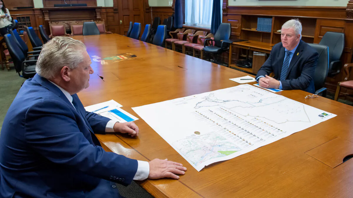 Ontario Premier Doug Ford and former head of the Canadian Armed Forces Gen. Rick Hillier look over a map in the Premier's office at the Ontario Legislature in Toronto on Nov. 27, 2020. (The Canadian Press/Frank Gunn)